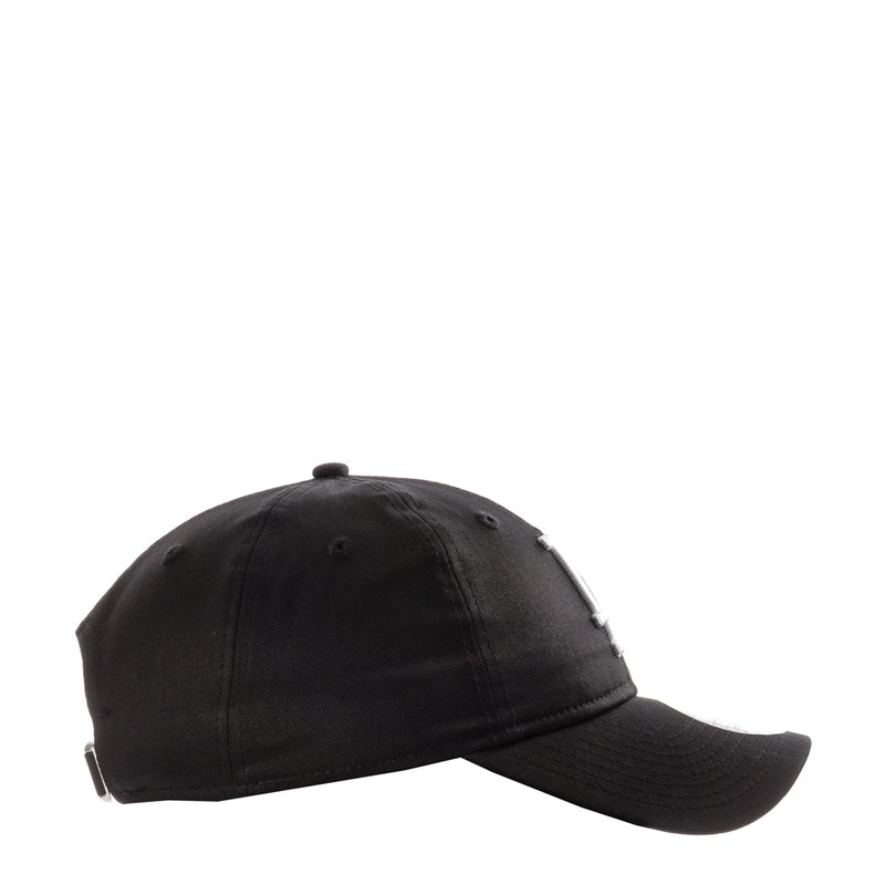 Black baseball cap with curved brim and top button, side view