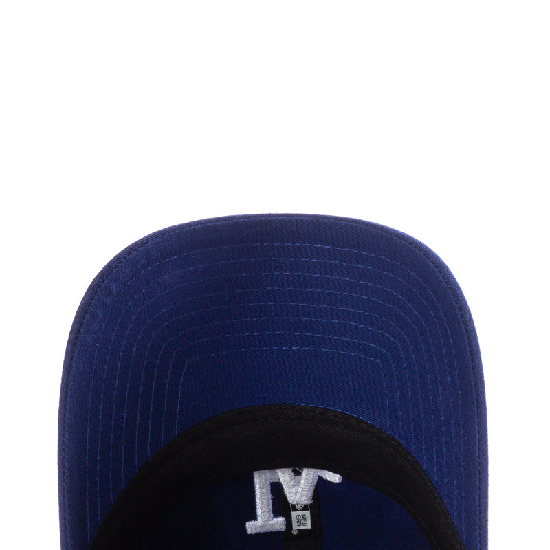 Royal blue baseball cap close-up of curved brim and black inner band