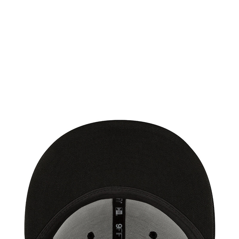 Black baseball cap showing interior brim and stitched panel