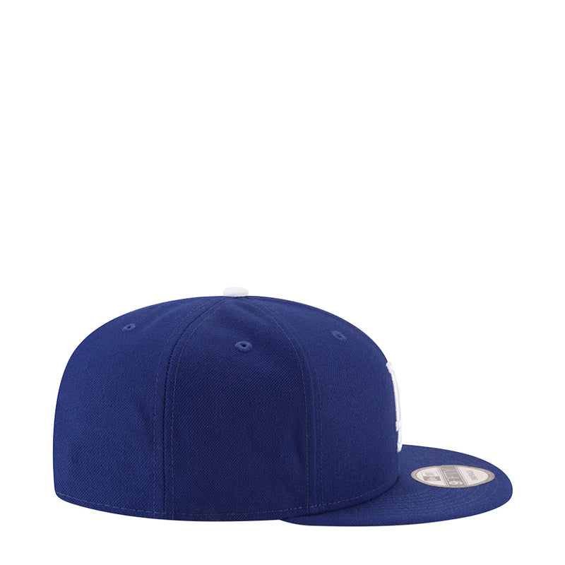 Royal blue baseball cap, side profile with curved brim and stitched crown.