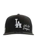 Black baseball cap with white LA logo and 'Let's Go Dodgers' script on front