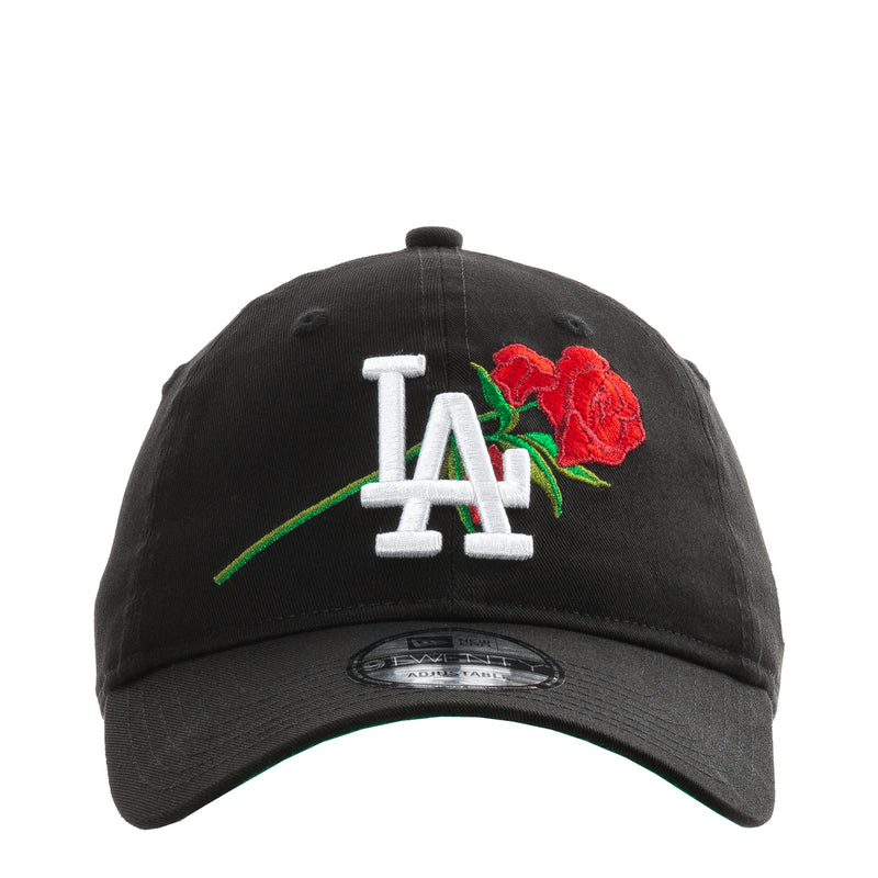 Black baseball cap with white LA logo and red rose embroidery, green accents