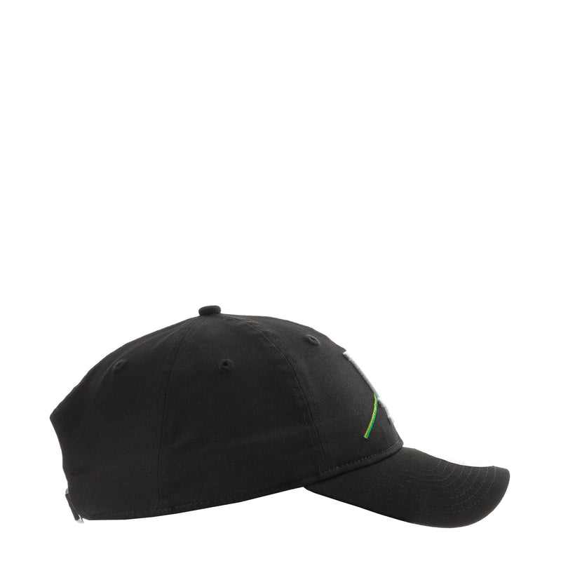 Black baseball cap, side view with small green stitched detail near crown