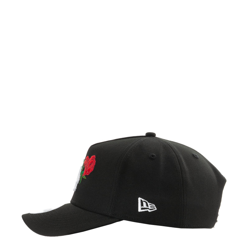 Black A-frame baseball cap with red rose patch on crown and New Era logo front