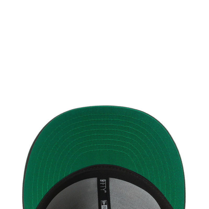 Green cap underside brim close-up with stitching