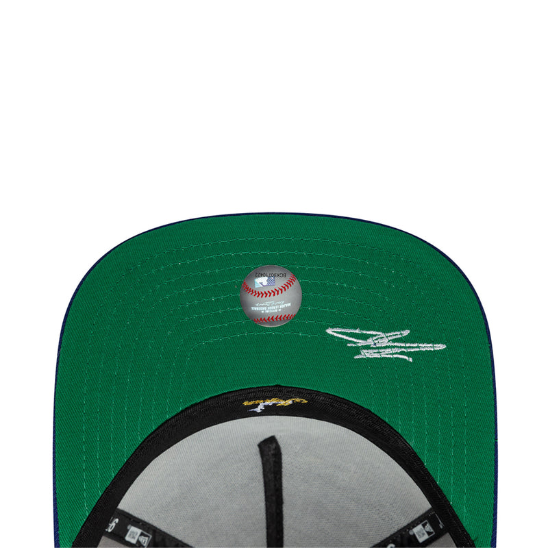 Green baseball cap with baseball graphic and white signature