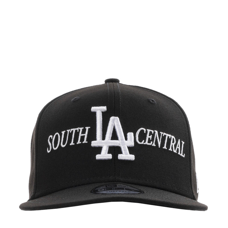 Black baseball cap with white LA and SOUTH CENTRAL embroidery, adjustable back strap