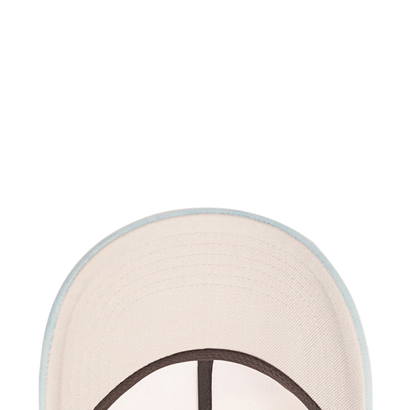 White baseball cap crown close-up with stitched fabric and dark trim edge