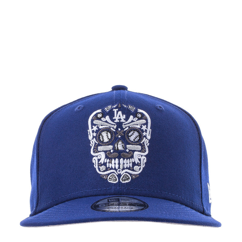 Royal blue baseball cap with white embroidered sugar skull and LA Dodgers crest