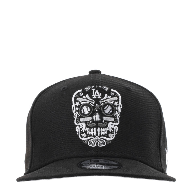 Black baseball cap with white embroidered sugar skull and LA logo at front
