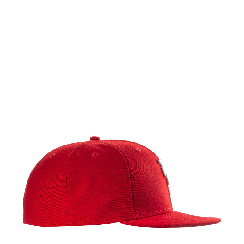 Red baseball cap with curved brim and stitched panel seams