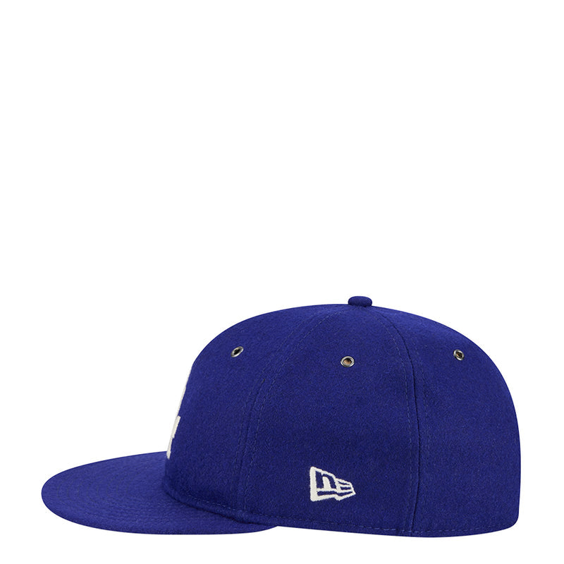 Royal blue baseball cap with small MLB-style logo patch on the side