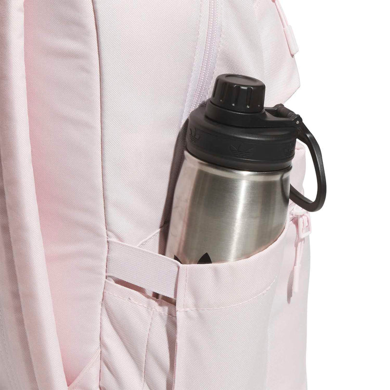 Light pink double-stacked backpack with side bottle pocket holding a stainless steel water bottle.
