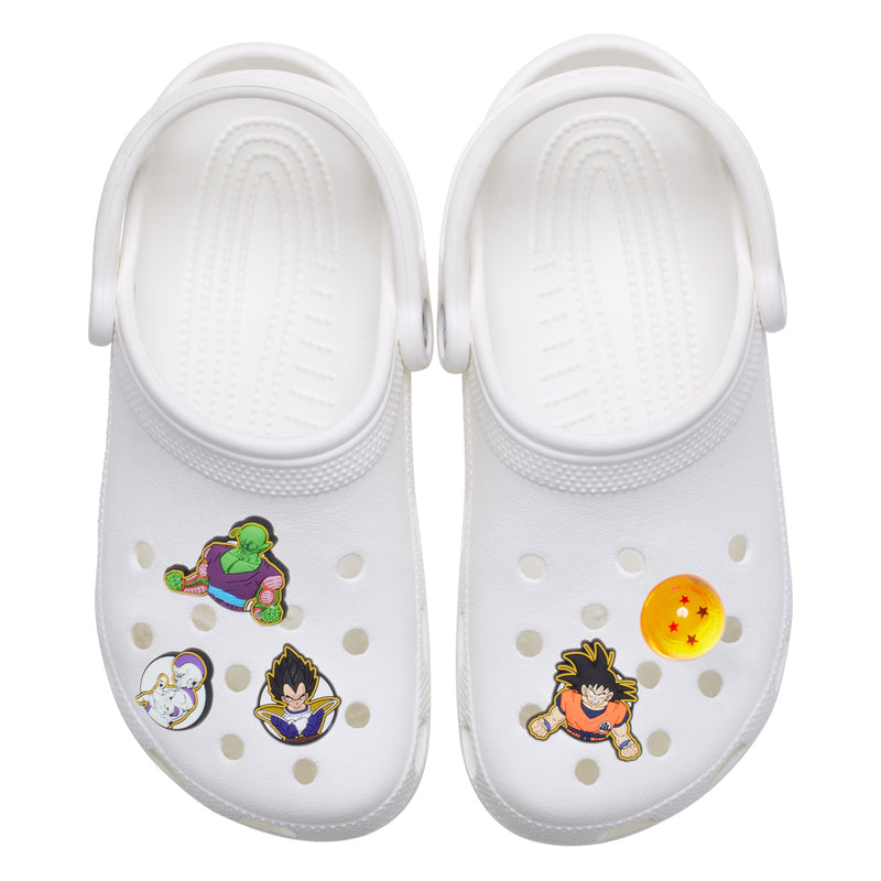 White clogs with Dragon Ball Z Jibbitz charms, including green fighter and star orb