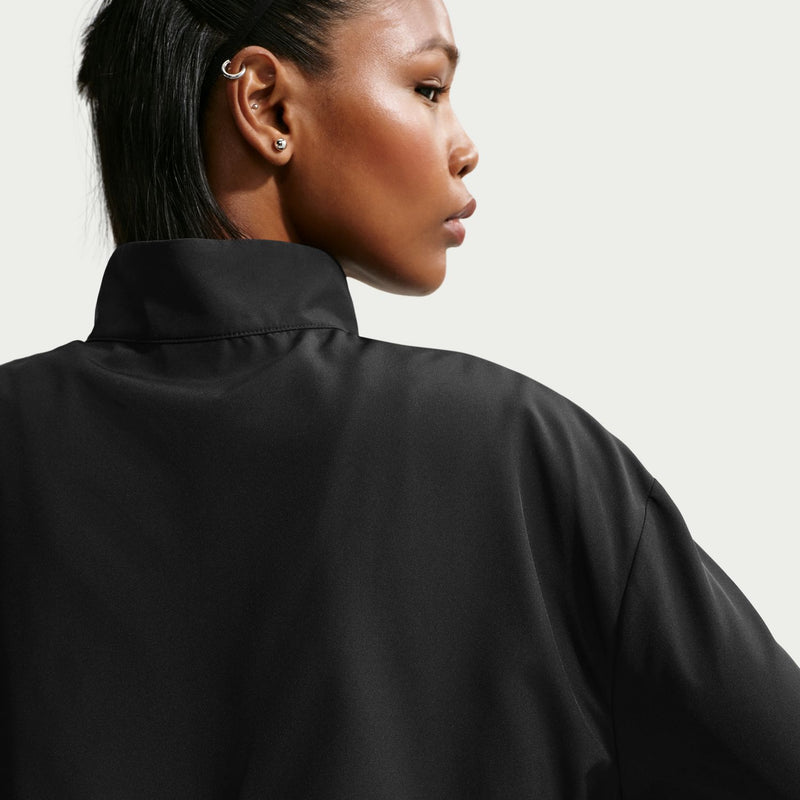 Women's black woven jacket collar detail with mock neck and zipper seam.