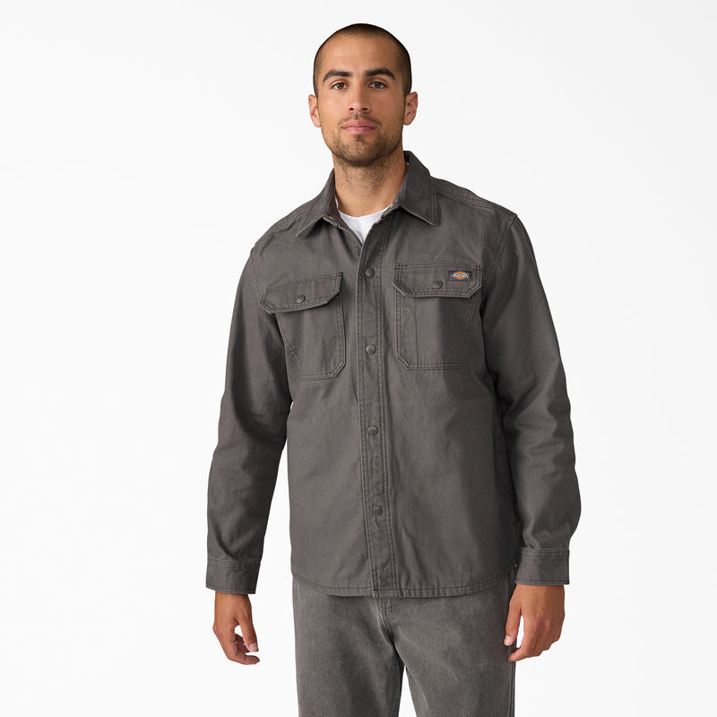 Men's duck shirt jacket in dark gray, button placket and chest flap pockets, worn by model.