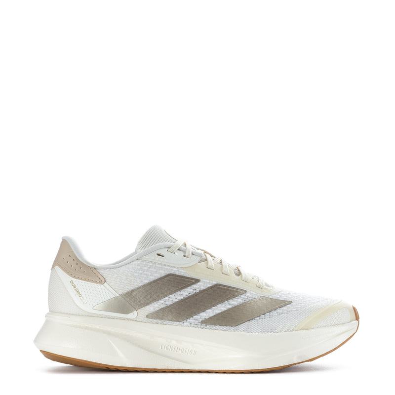 White women's running shoes with metallic 3-stripe accents and gum rubber sole