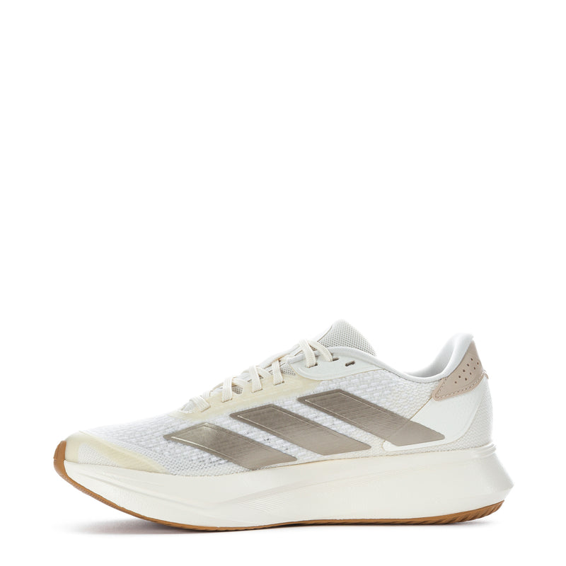 White women's running shoes with taupe-gold stripes, lace-up front, gum sole