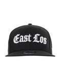 Black baseball cap with white East Los logo; curved brim and snapback strap