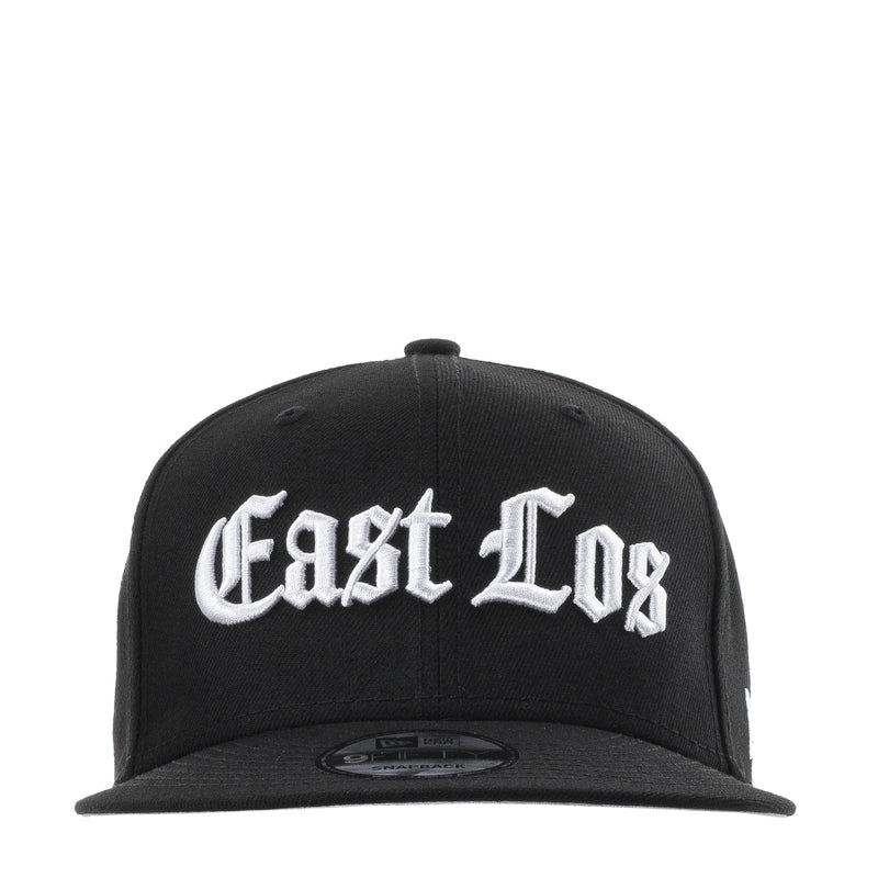 Black baseball cap with white East Los logo; curved brim and snapback strap