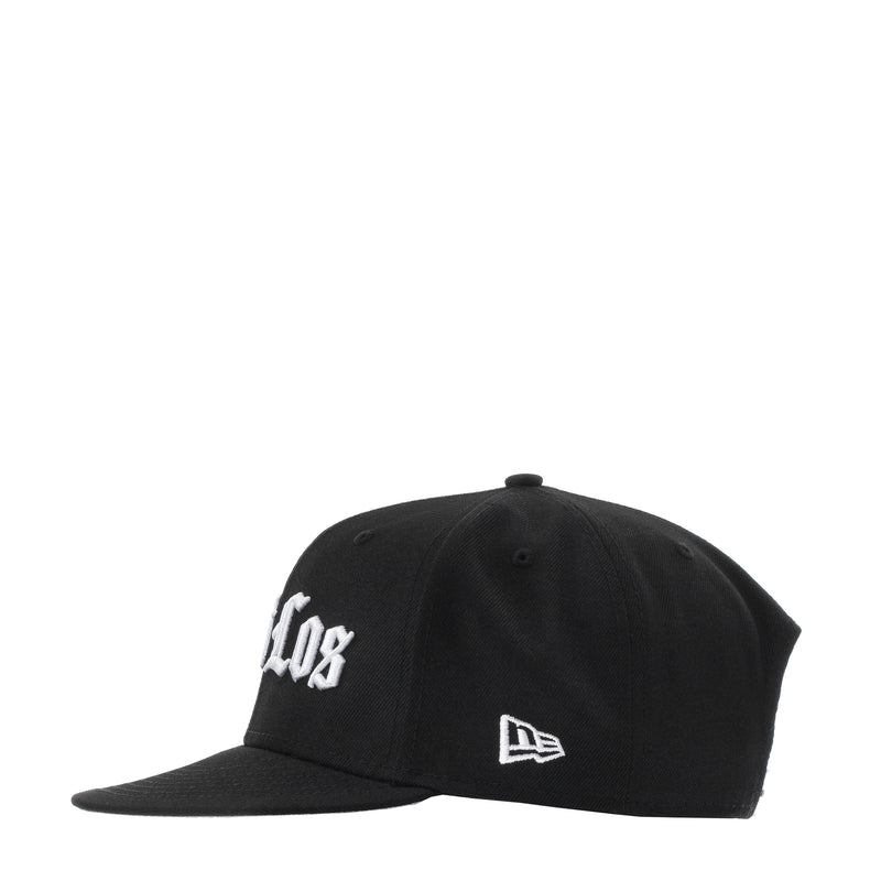 Black baseball cap with white side logo and New Era flag patch; curved brim