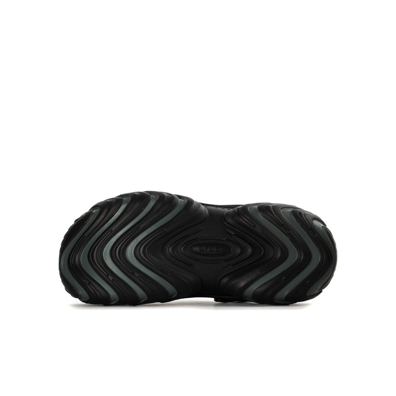 Black youth clog sole view with textured tread and wavy pattern