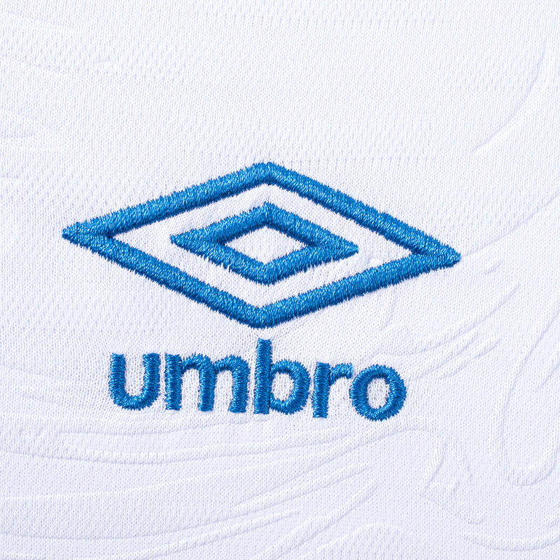 Close-up of Umbro logo on white soccer jersey fabric