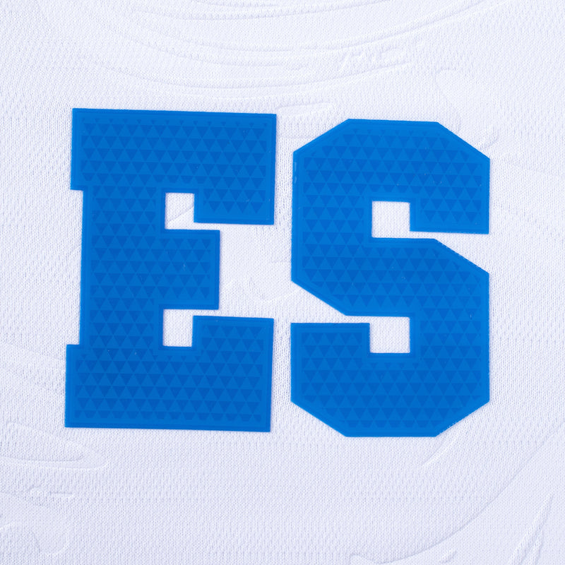 Close-up of large blue ES lettering on white soccer jersey