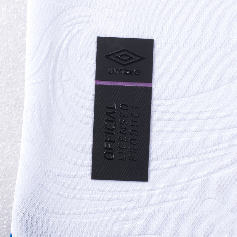 Close-up of Umbro neck label on white soccer jersey