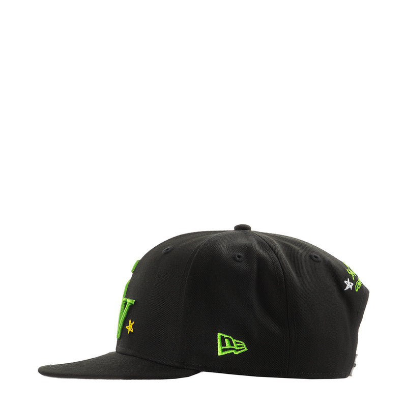 Black baseball cap with green symbols and small yellow star accents
