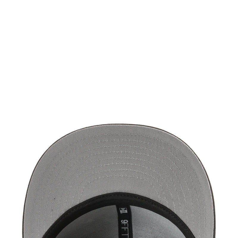 Black baseball cap underside with gray fabric panel and black brim trim