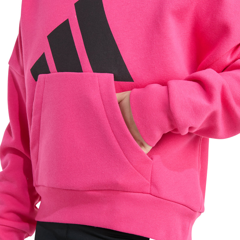 Close-up of pink fleece hoodie pocket and large black logo across the chest