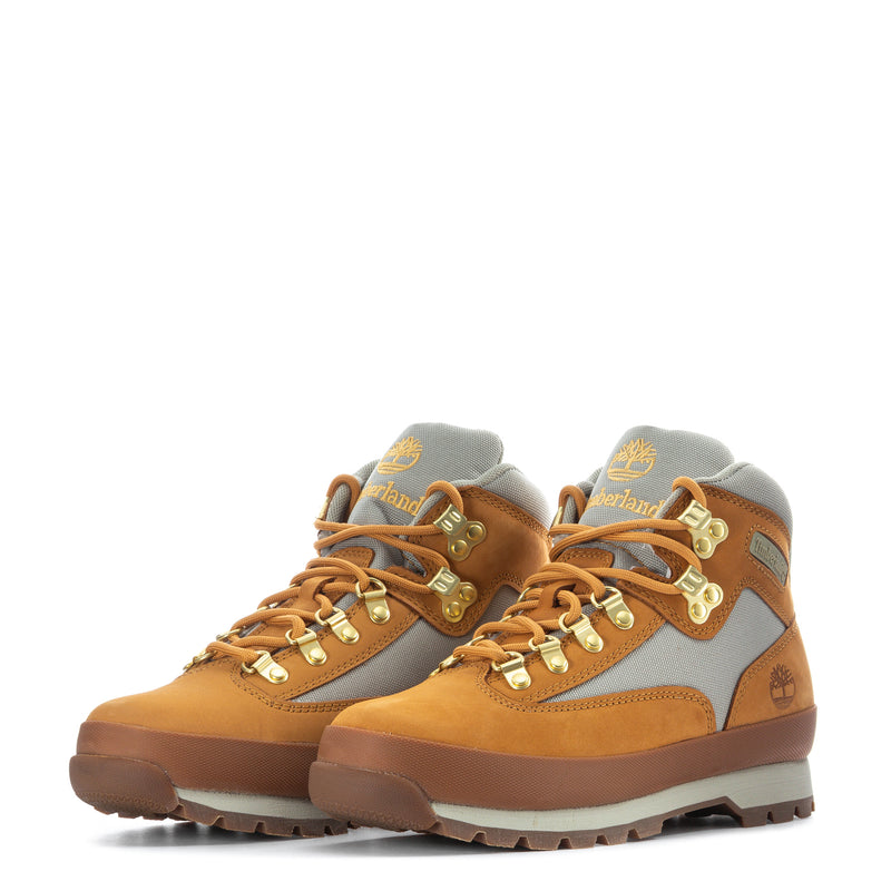Pair of men's Timberland hiker boots, tan and gray with gold eyelets and laces