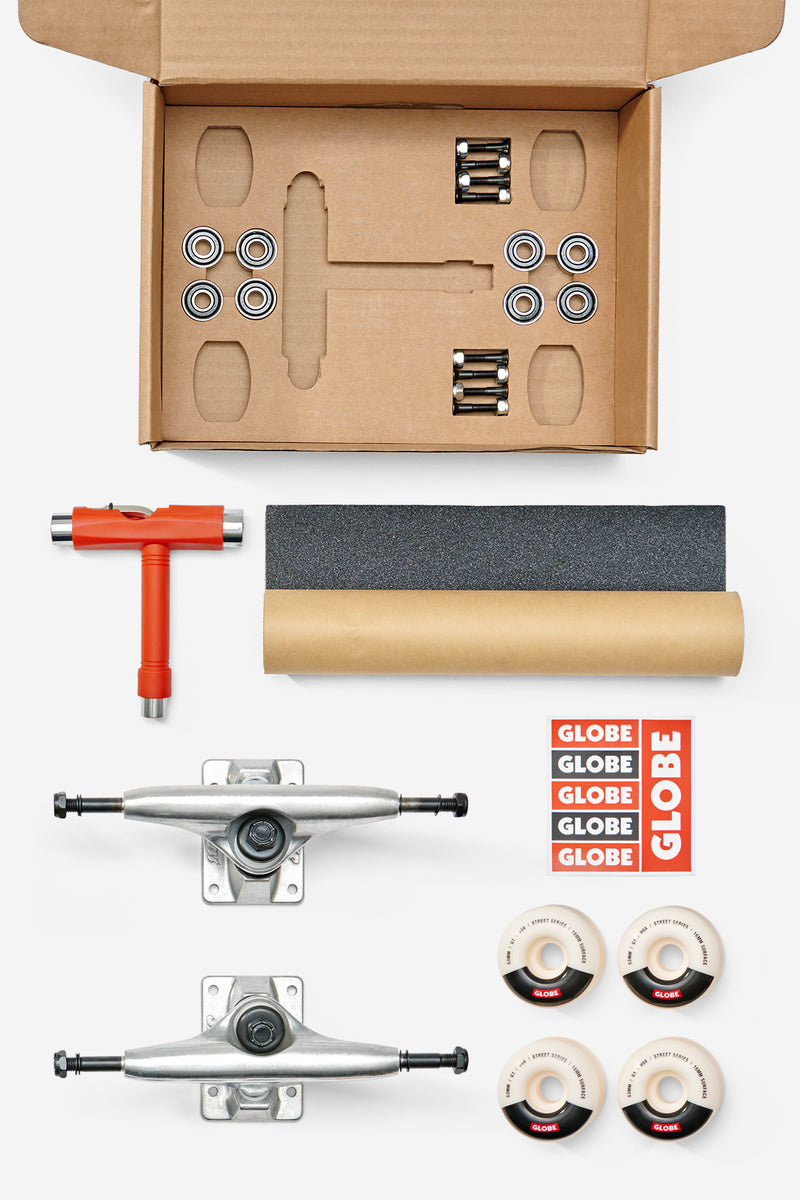 Opened Everything But The Deck Kit Accessories 5.0 with trucks grip tape wheels and tools laid out