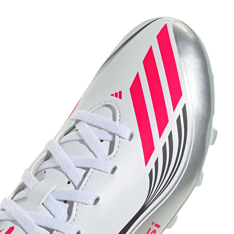 Kids soccer cleat close-up, white synthetic upper with red logo and ribbed detailing