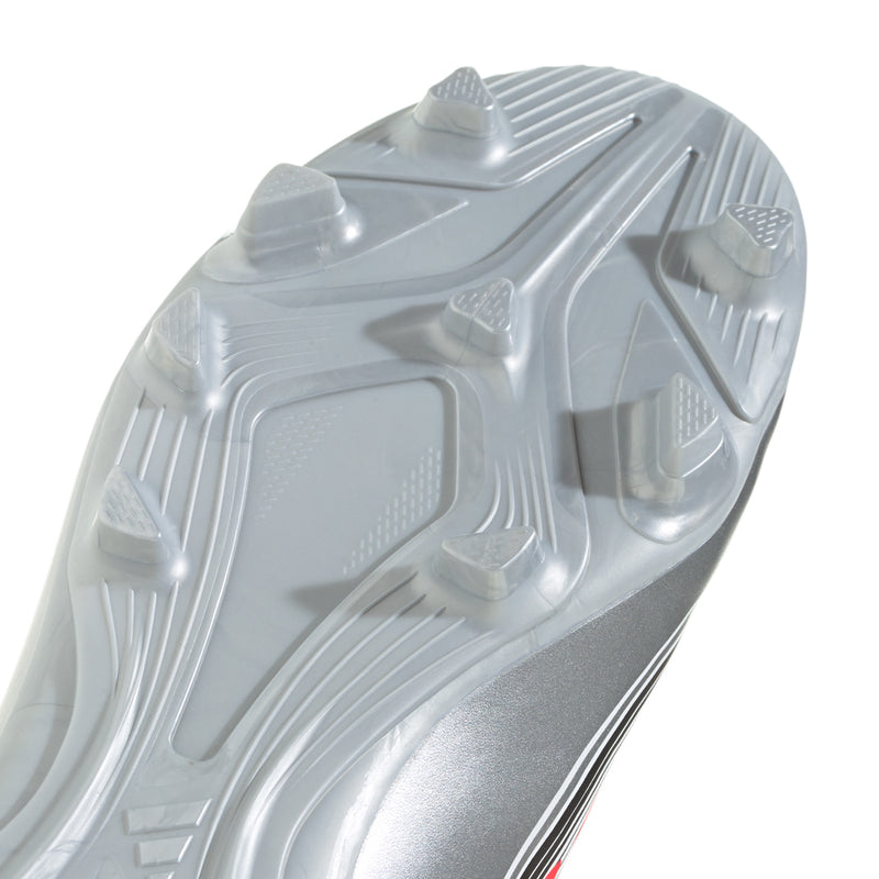 Kids soccer cleat outsole close-up, molded studs on white/gray rubber sole