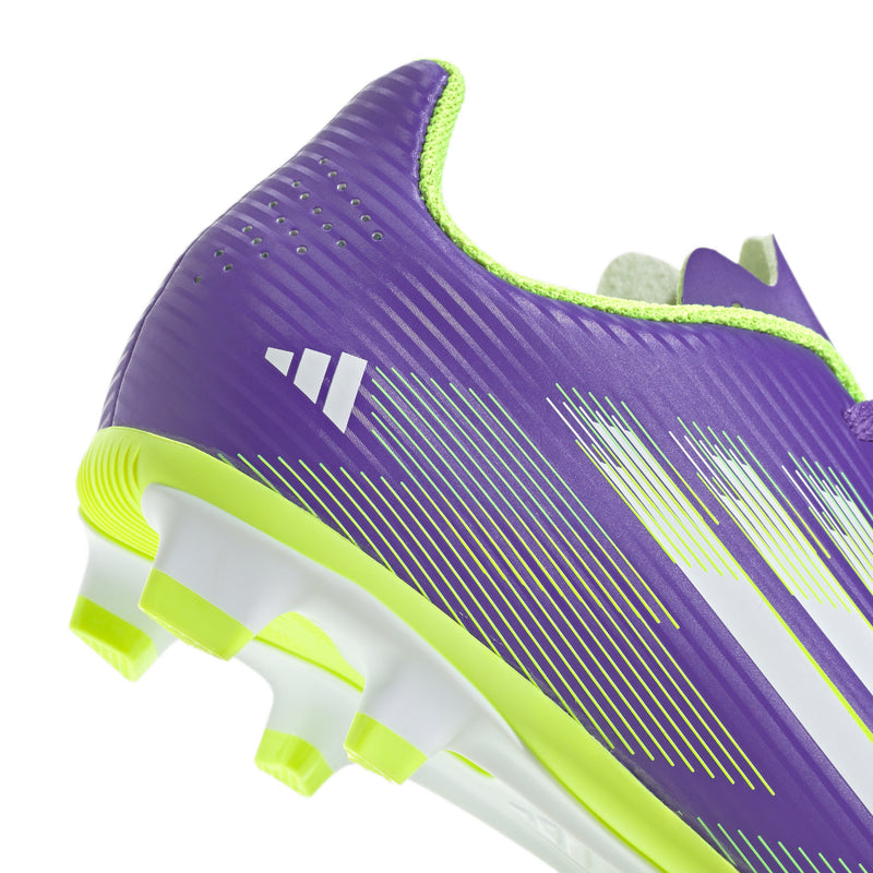 Purple youth soccer cleat side view with neon green outsole and white stripe graphics