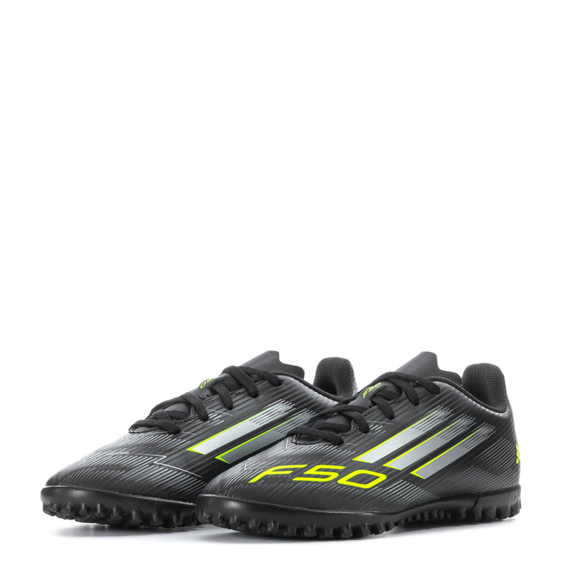 Youth black soccer cleats with neon green F50 branding, lace-up front, turf studs
