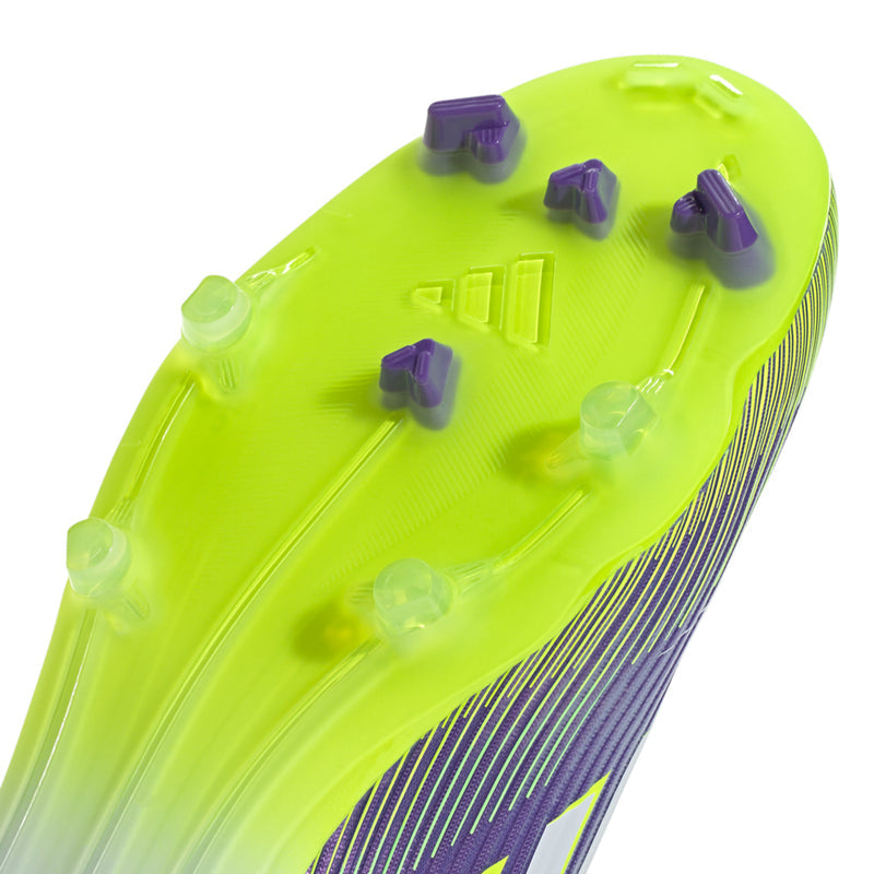 Close-up of men's soccer cleat outsole with lime plate and purple-tipped studs