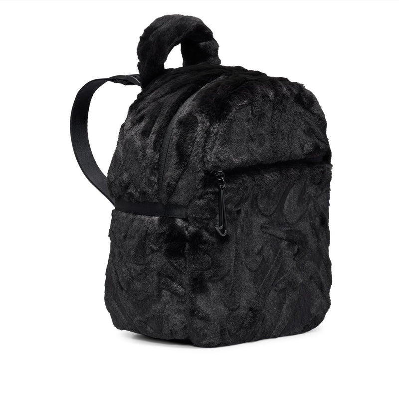 Black faux fur mini backpack with carry handle and long shoulder strap.