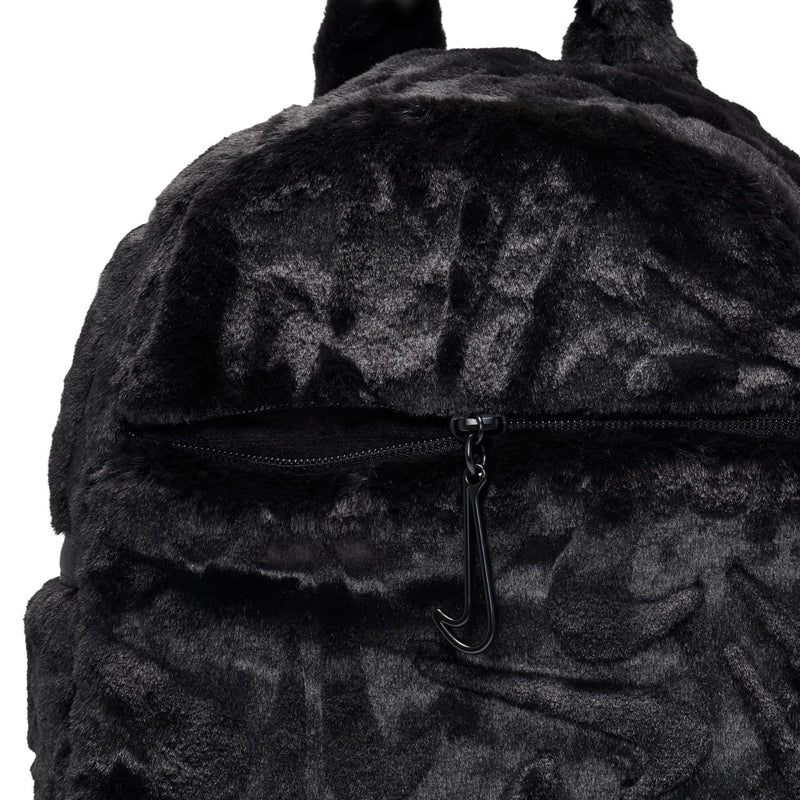 Black faux fur mini backpack with front zipper and metal pull ring.