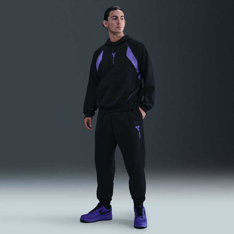 Black jogger pants with drawstring waist and purple side emblem, full-length