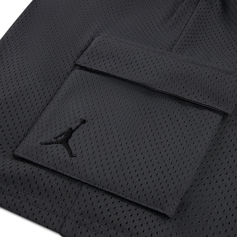 Youth cargo shorts fabric close-up with logo on side pocket and flap