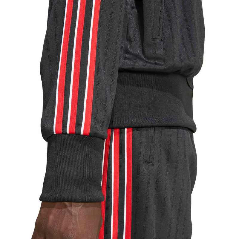 Men's black track jacket sleeve with red and white triple stripe detail and ribbed cuff
