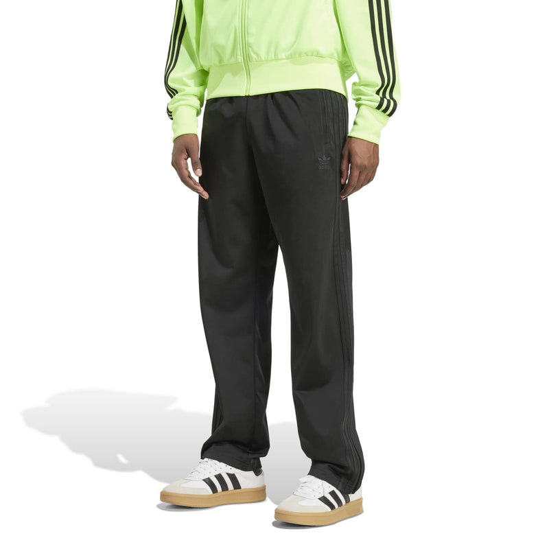 Men's black track pant with relaxed fit, side pockets, and tapered ankle.