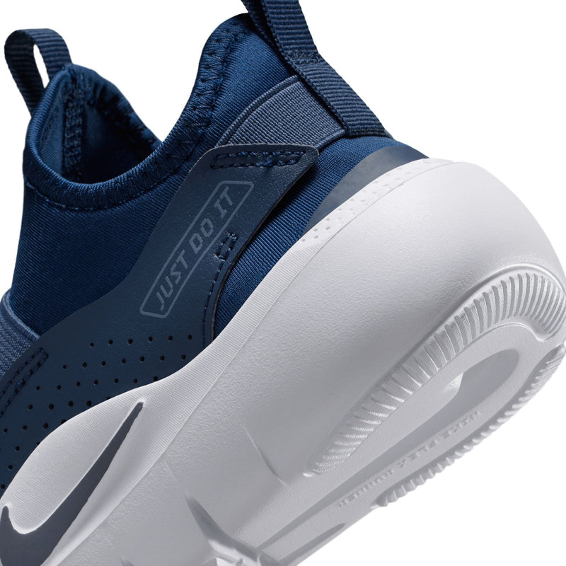 Kids navy slip-on shoe side close-up with strap, mesh upper, and Nike swoosh