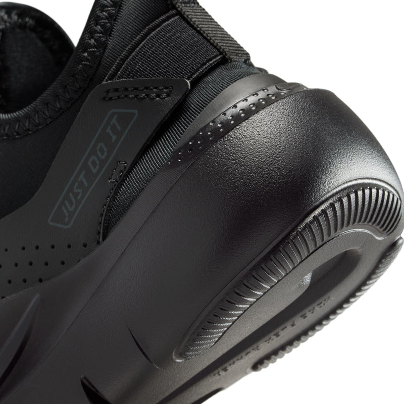 Kids black running shoe close-up with perforations, swoosh, and padded side panel