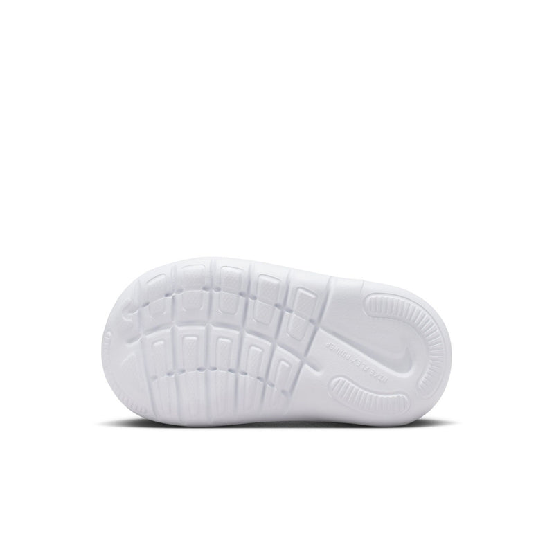 White outsole of black toddler sneaker with tread pattern and Nike swoosh