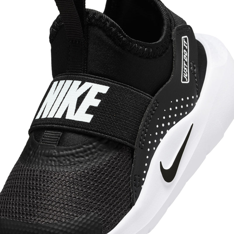 Black knit toddler sneaker close-up with white Nike logo, swoosh, and strap