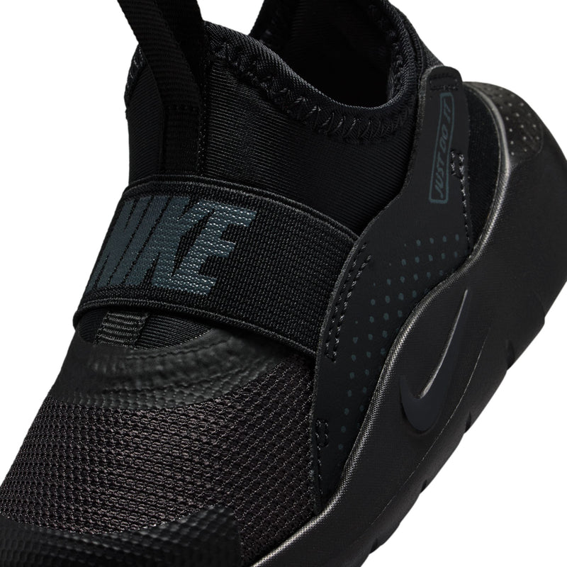 Toddler black slip-on sneakers, close-up of strap panel and swoosh detail